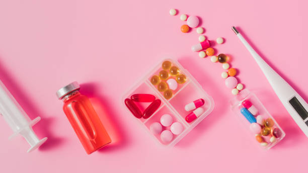 istock top view of different medicines and electric thermometer on pink surface 1016049888