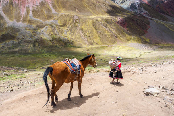 Cusco, Peru - Oct 10, 2017: The native Peruvian is hiking with the horse at Mountain Rainbow.