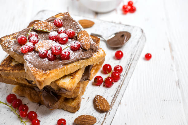 istock stack of fried toast with chocolate cream, red currant and almonds 1016071490