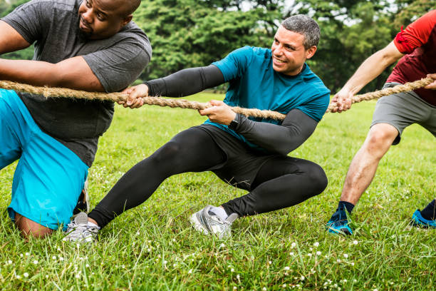 istock Team competing in tug of war 1016074602