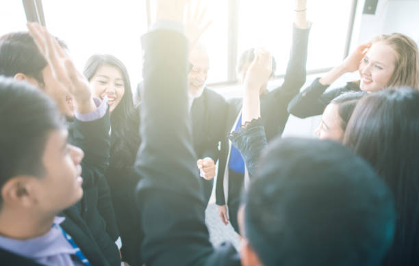 istock Happy business people team hands raised for success 1016074964