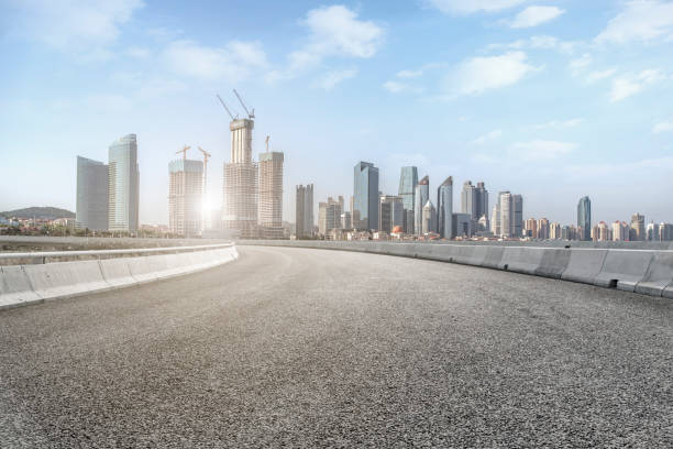istock Qingdao modern construction commercial building office building with prospect highway asphalt pavement 1016077410