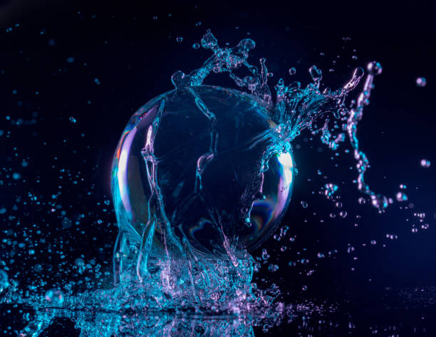 water splashing on a floating ball blue and purple water splashing over a transparent ball in a dark background levitation photos stock pictures, royalty-free photos & images
