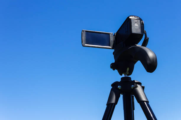 istock Camcorder on a tripod against a clear blue sky 1016083176