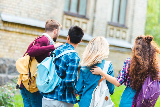 istock back view of students with backpacks walking on street 1016086646