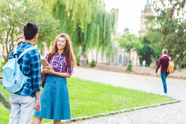 istock partial view of multiracial students having conversation in park 1016086710