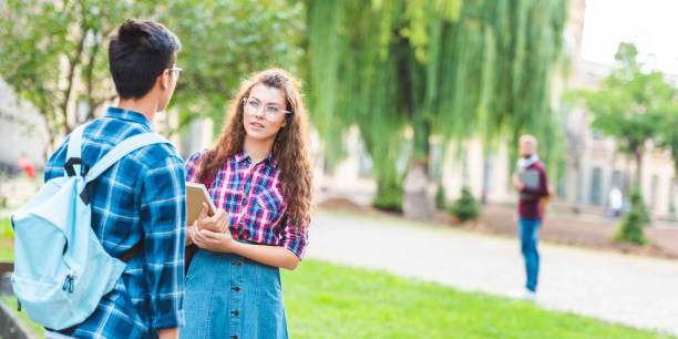 istock partial view of multiracial students having conversation in park 1016087588