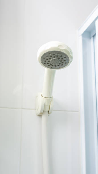 istock Old and dirty shower head in a bathroom. 1016087644