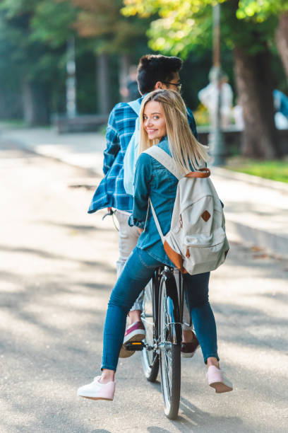 istock partial view of students riding bicycle together on street 1016087674