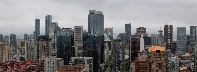Downtown Vancouver, British Columbia, Canada - May 16, 2018: Aerial view of the modern city skyline during a gloomy cloudy day.