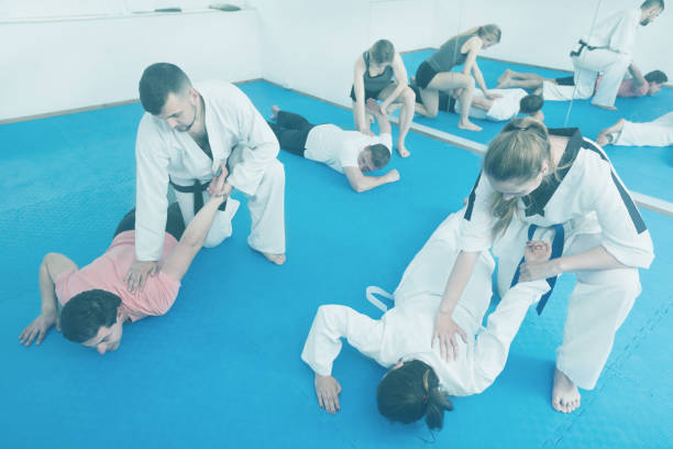 istock Adults practicing new taekwondo holds 1016099222