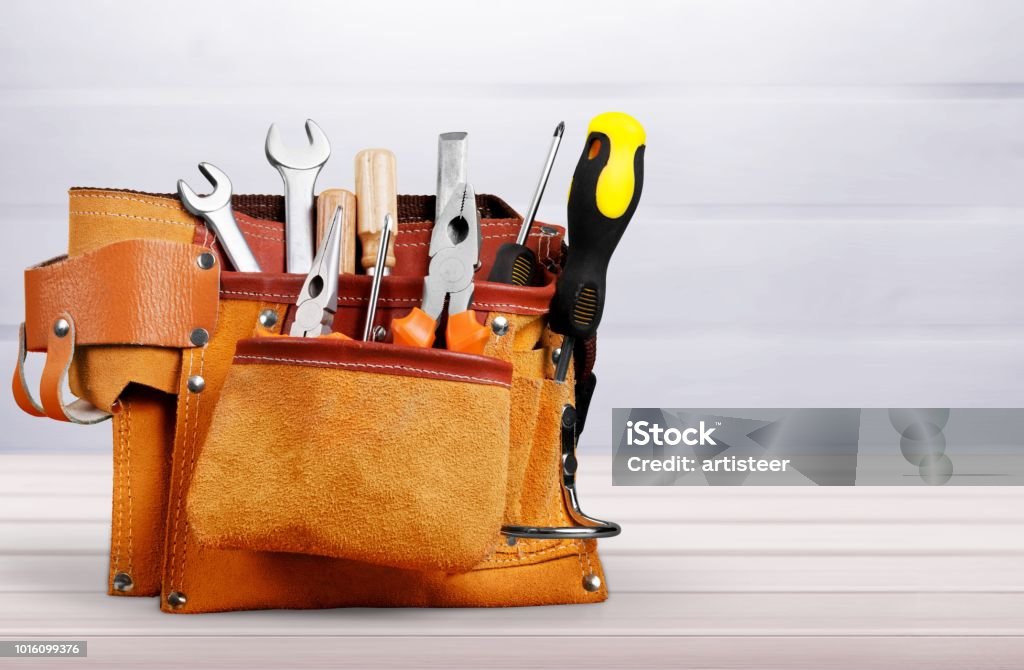 Background. Tool belt with tools on desk Work Tool Stock Photo