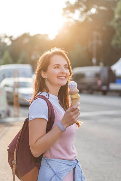 istock young happy woman with backpack holding ice cream 1016100240