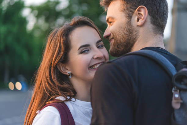 istock selective focus of smiling young couple with backpacks 1016102630