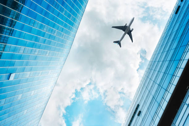 istock Plane flying over the skyscrapers 1016115486