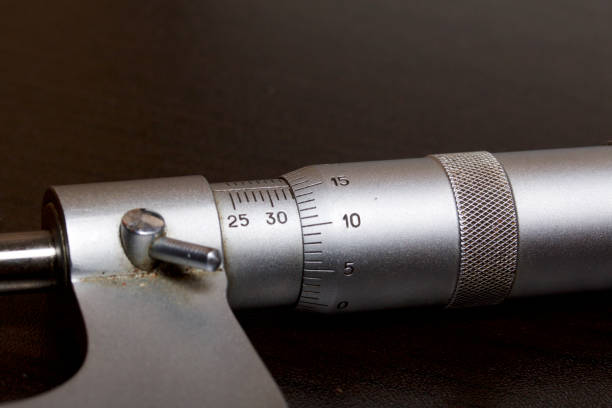 istock Micrometer with a circular scale for external measurements and a measuring range of 25 - 50 mm. On a dark background. 1016115744