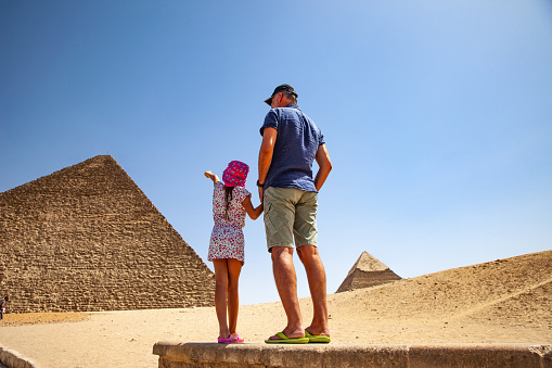 Father and Daughter Looking at Kheops Pyramid in Giza.