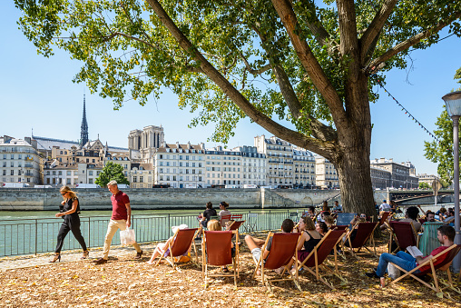 Paris, France - August 2, 2018: Every July and August since 2002 the banks of the Seine are converted into seaside walk with open-air cafes and deck chairs during Paris-Plages summer event.