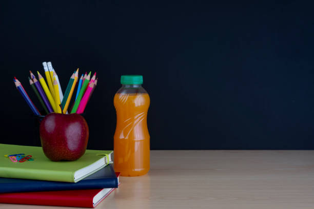 istock apple on books with pencils and empty blackboard , back to school 1016124966
