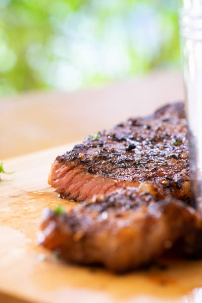 Steak with fries and sauce on a wooden tray