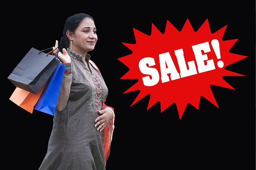 Indian woman carrying shopping bags on the event of big sale
