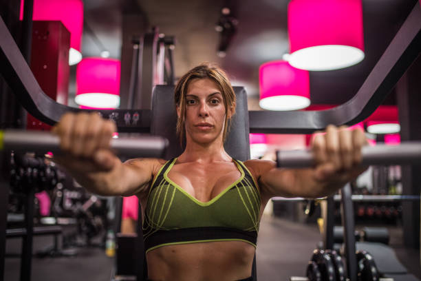 Woman workout in the gym, personal trainer, colorful photos and realistic training. Very good musculature and body shape.