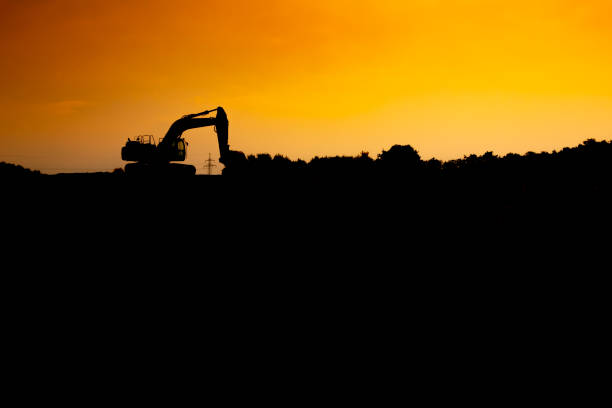 istock Silhouette of a excavator in the sunset 1016133794