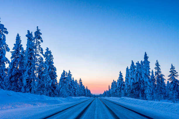 istock Evening on the winter road in Finland 1016160238