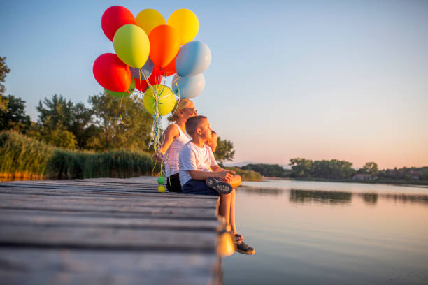 istock Playing with balloons by the lake 1016160258