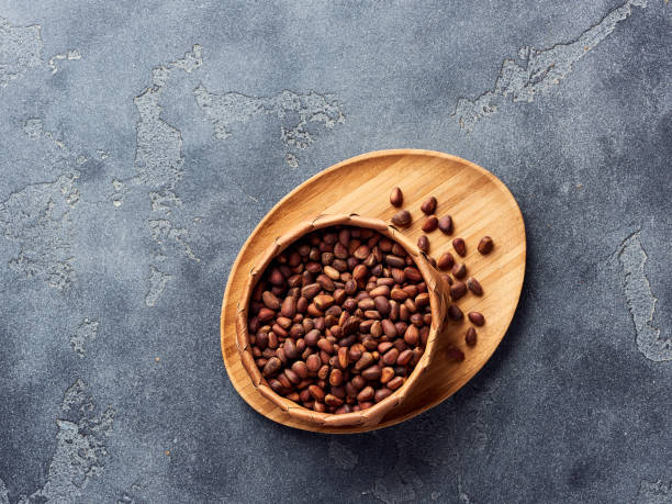istock Pine nuts in bowl on gray stone table. Top view with copy space 1016160764