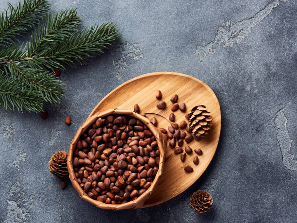 istock Pine nuts in bowl on gray stone table. Top view with copy space 1016160822