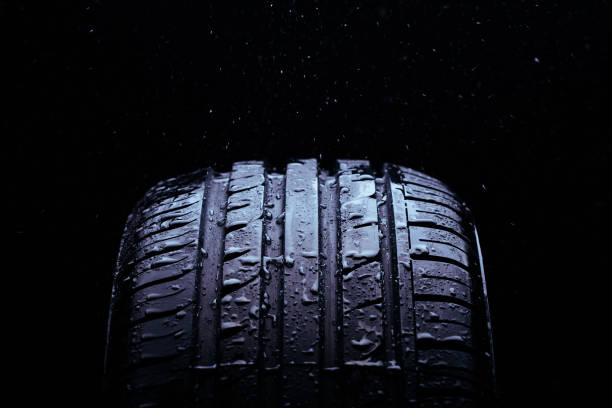 istock Water splashing on a new symmetrical tire during the rain 1016165064