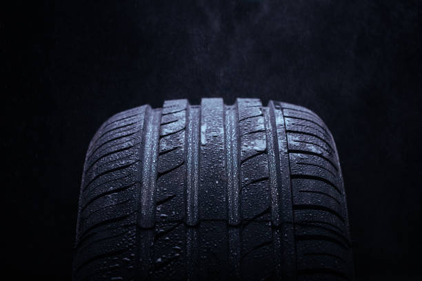 istock Water splashing on a new symmetrical tire during the rain 1016168516