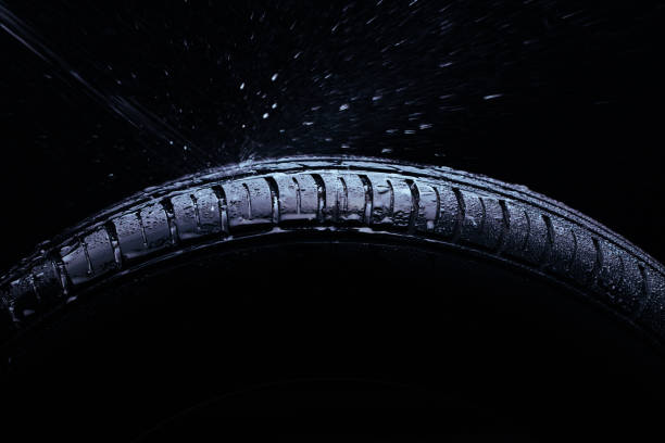 istock Water splashing on a new symmetrical tire during the rain 1016168648