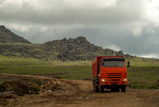 istock dump truck is driving on a mountain road 1016168936
