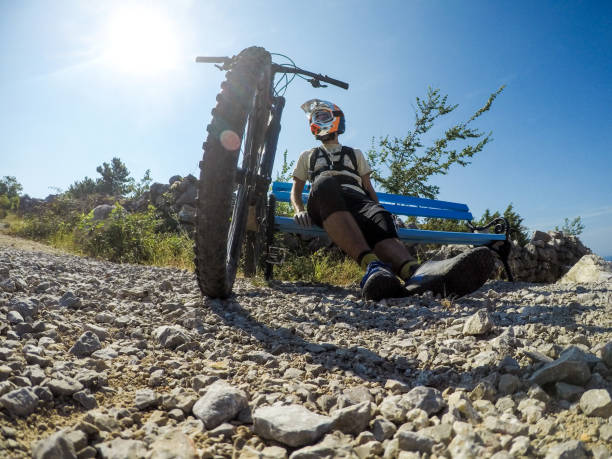 istock Mountain biker sitting and resting on hot day 1016174006