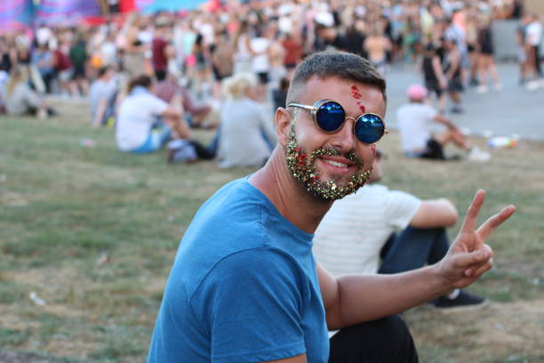 istock Fancy male giving peace sign in crowded event 1016174558