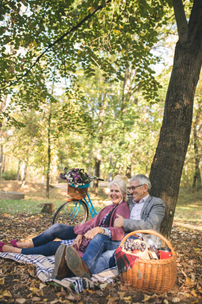 istock Romantic senior couple seated on the grass and relaxing while picnic. 1016175290