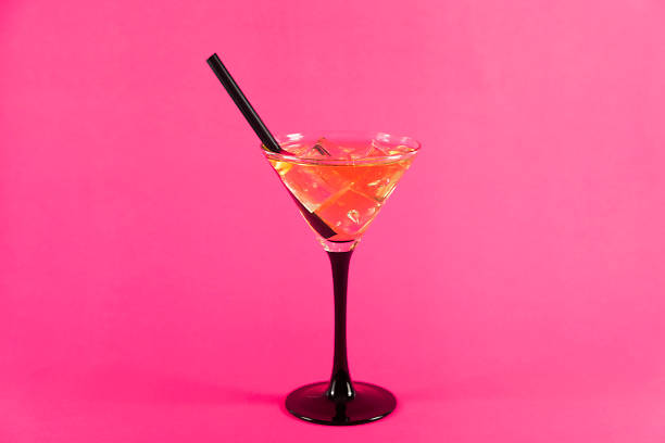istock cocktail with black straw on pink 1016183928