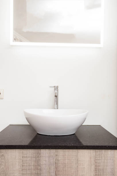 Chrome tap and new white drop-shaped sink