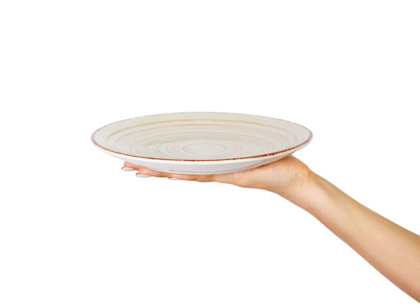 istock One white kitchen plate on human hand. perspective view, isolated on white background 1016190132