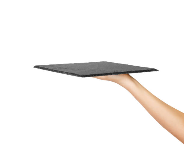 istock woman hand holding empty square slate platter. perspective view Template for your design. isolated on white background 1016190158