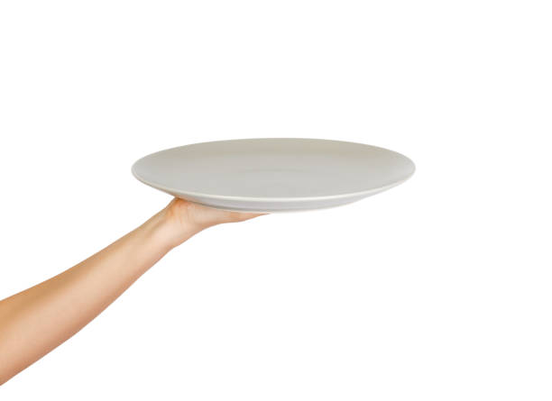 istock white kitchen plate on hand on white background. perspective view, isolated on white background 1016190160