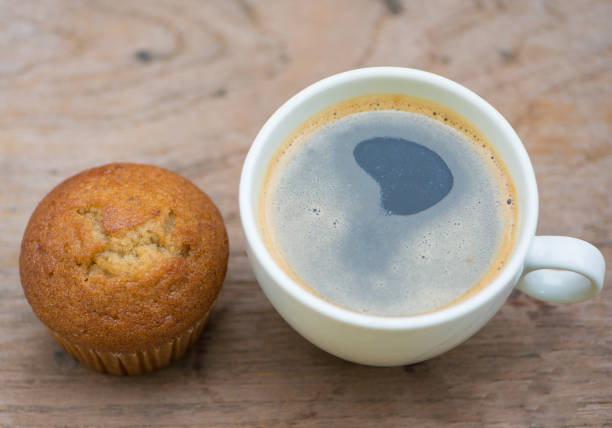 istock Banana cup cake and black coffee on wood table 1016204764