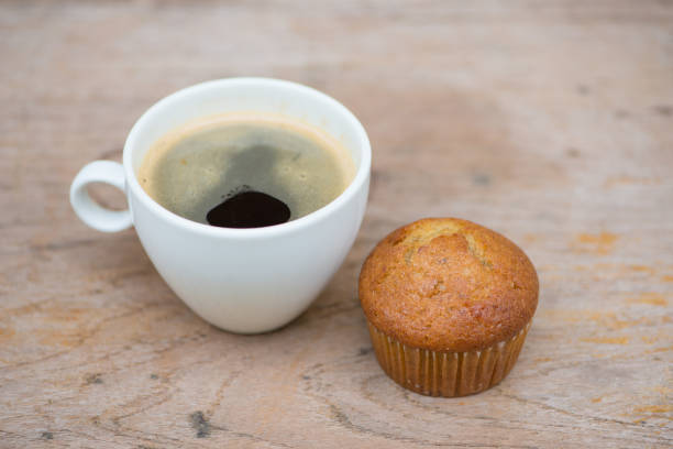 istock Banana cup cake and black coffee on wood table 1016204782