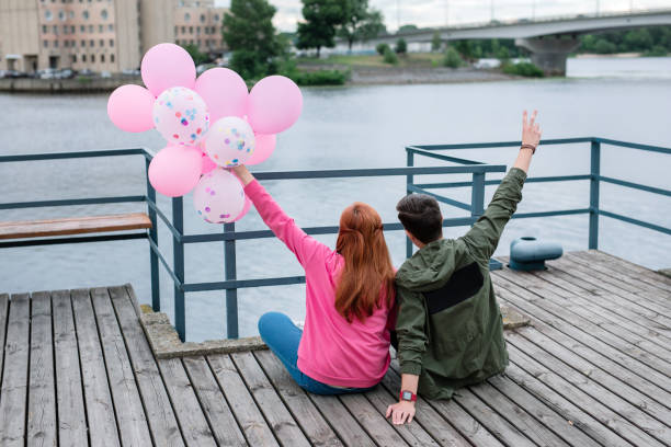 istock Joyful nice couple sitting on the dock 1016204794