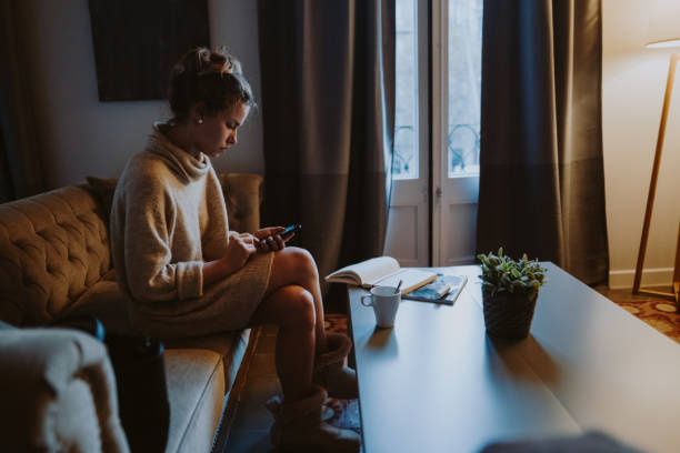 istock Sad woman at home texting 1016210528