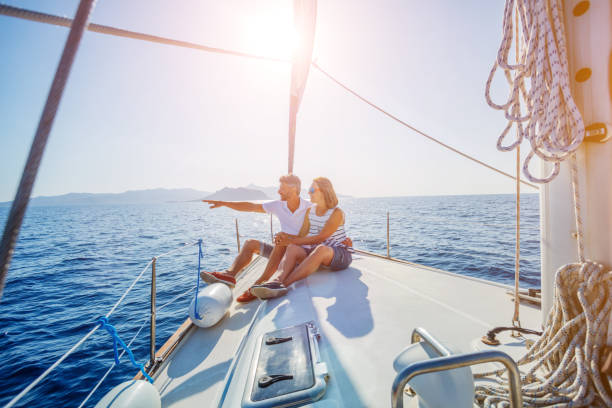 Young couple relaxing on the yacht Young couple relaxing on the yacht cruise. Travel adventure, yachting vacation. wealthy lifestyle stock pictures, royalty-free photos & images