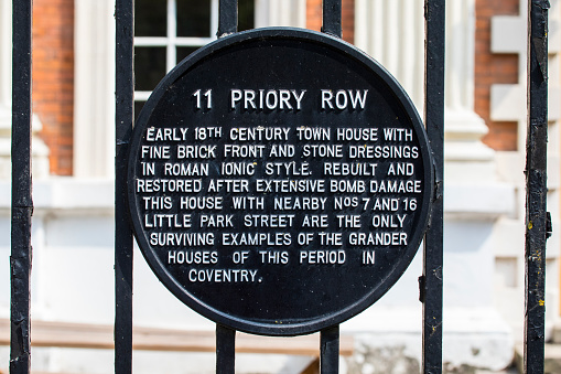 A plaque at 11 Priory Row in the historic city centre of Coventry, UK - detailing the history of the building.