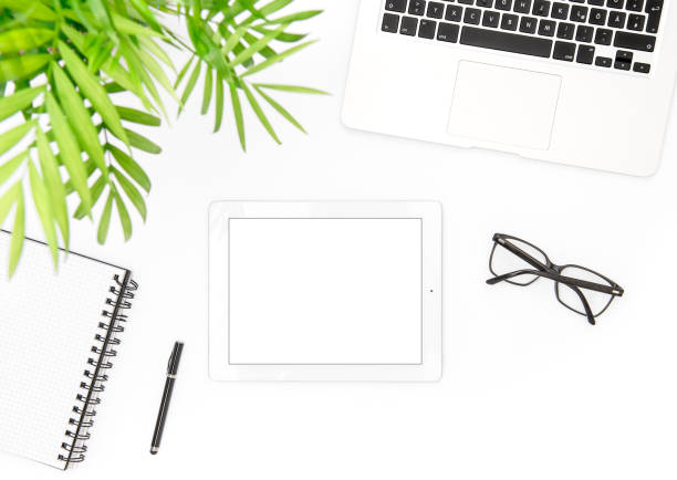 istock Office desk flat lay Laptop tablet notebook green plant 1016223420